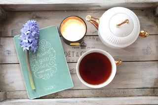 Relaxing evening routine with candle, herbal tea and aromatherapy roll-on